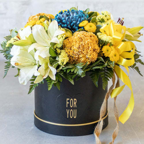 Floral arrangement in a black box labeled 'For You' on a light background