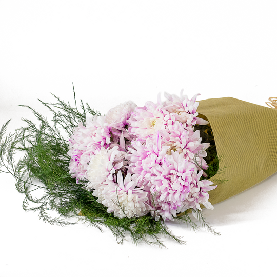 Bouquet of pink and white flowers wrapped in brown paper on a white background