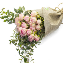 Load image into Gallery viewer, Bouquet of pink roses wrapped in burlap on a white background
