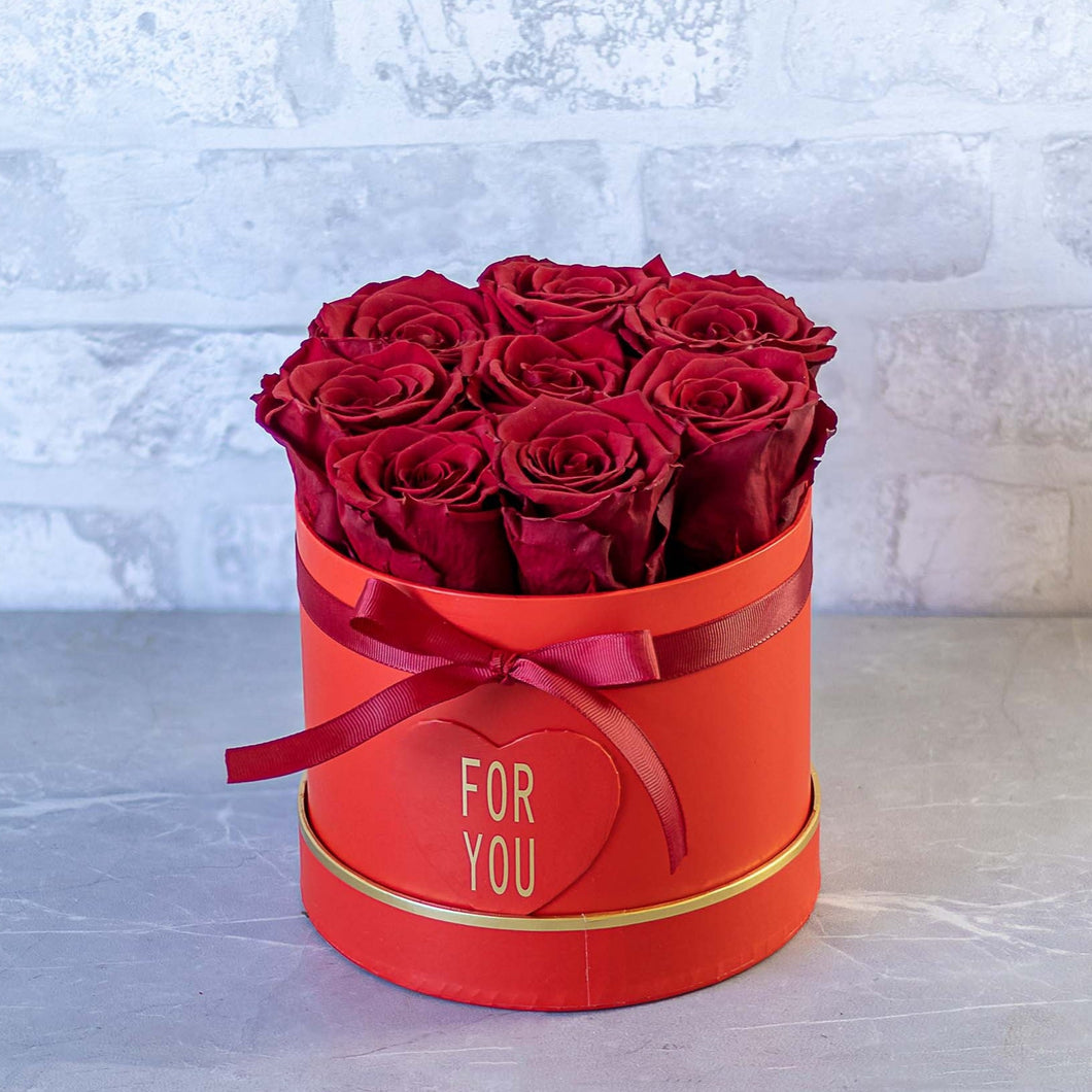 Red roses in a red box with 'FOR YOU' text on a light gray background