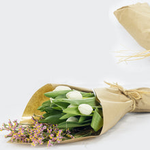 Load image into Gallery viewer, Bouquet of white tulips wrapped in brown paper on a light background
